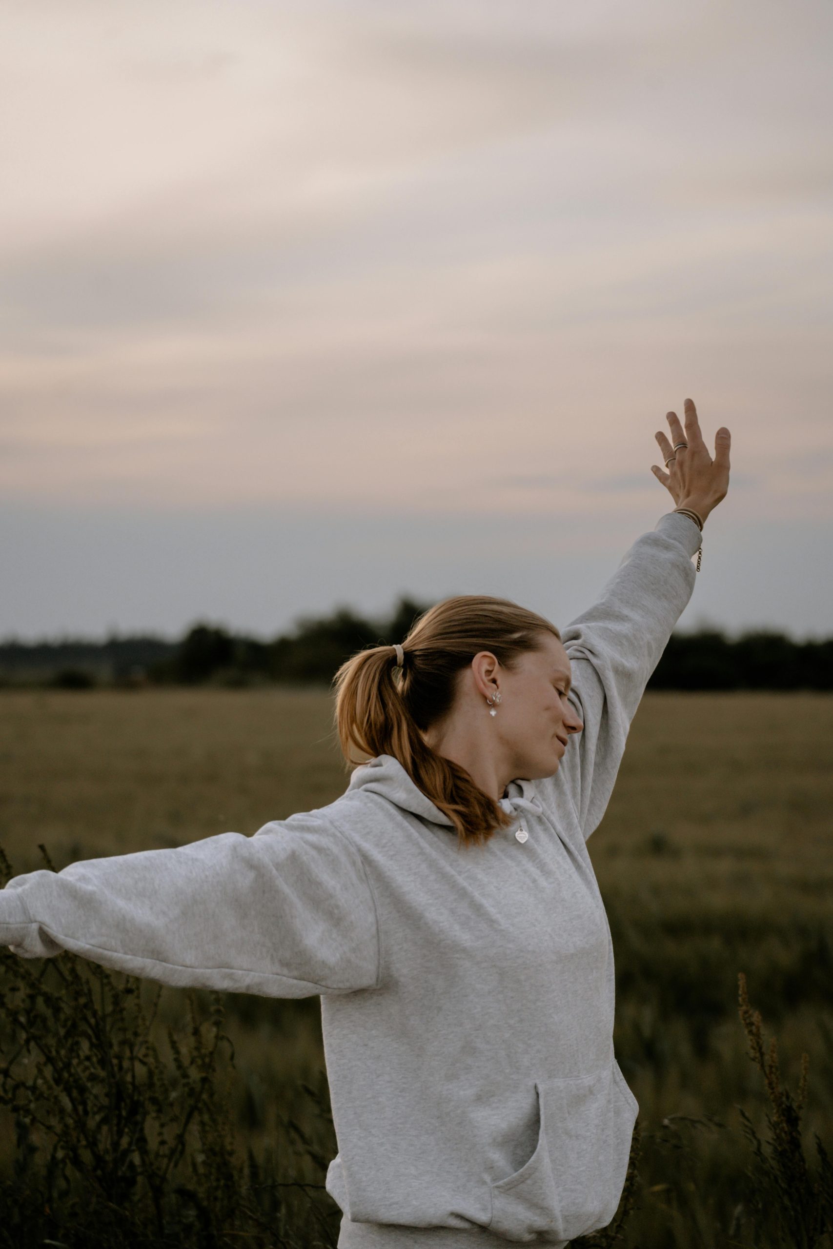 A peaceful woman enjoying time outdoors, representing the positive connection between Christianity and mental health and finding emotional balance through faith.