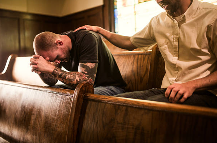 A man praying in a church, reflecting on the painful question: why do i pray and nothing changes and how to find hope in silence.