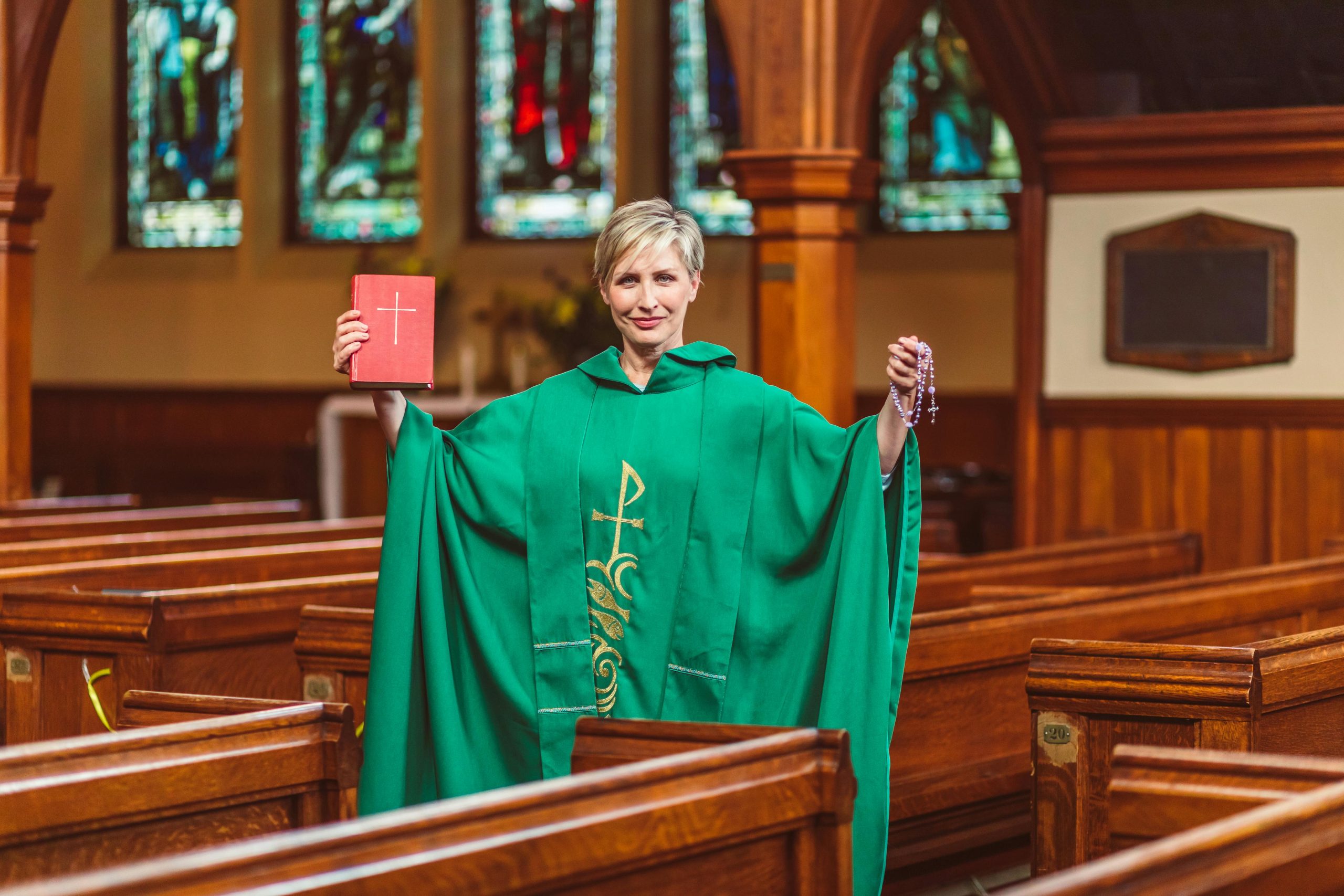 woman in liturgical clerical clothing serving in a church, symbolizing the role of women in Church leadership and contemporary ministry.