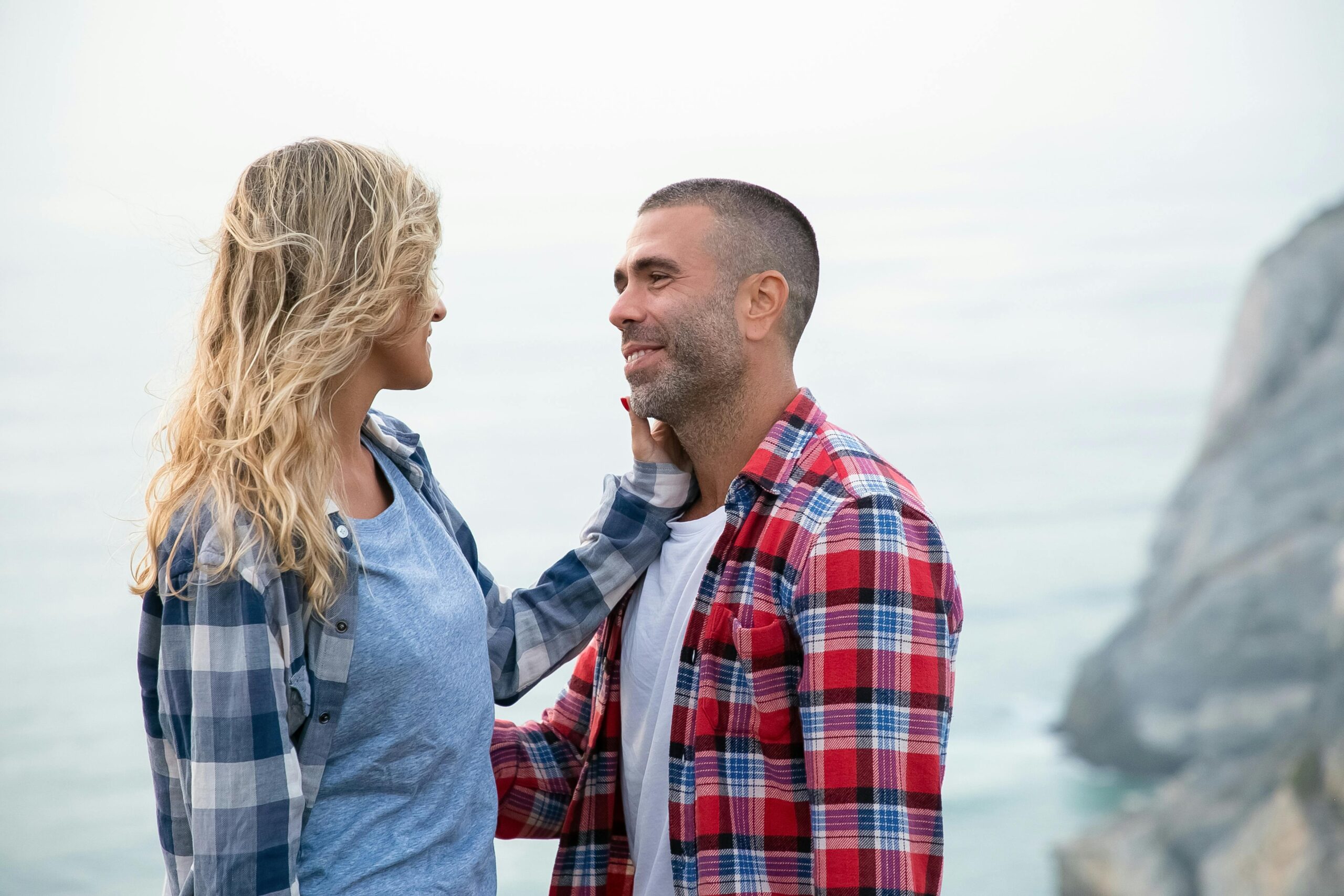 A happy couple looking into each other's eyes and smiling, representing healthy Christian communication as a path of love.